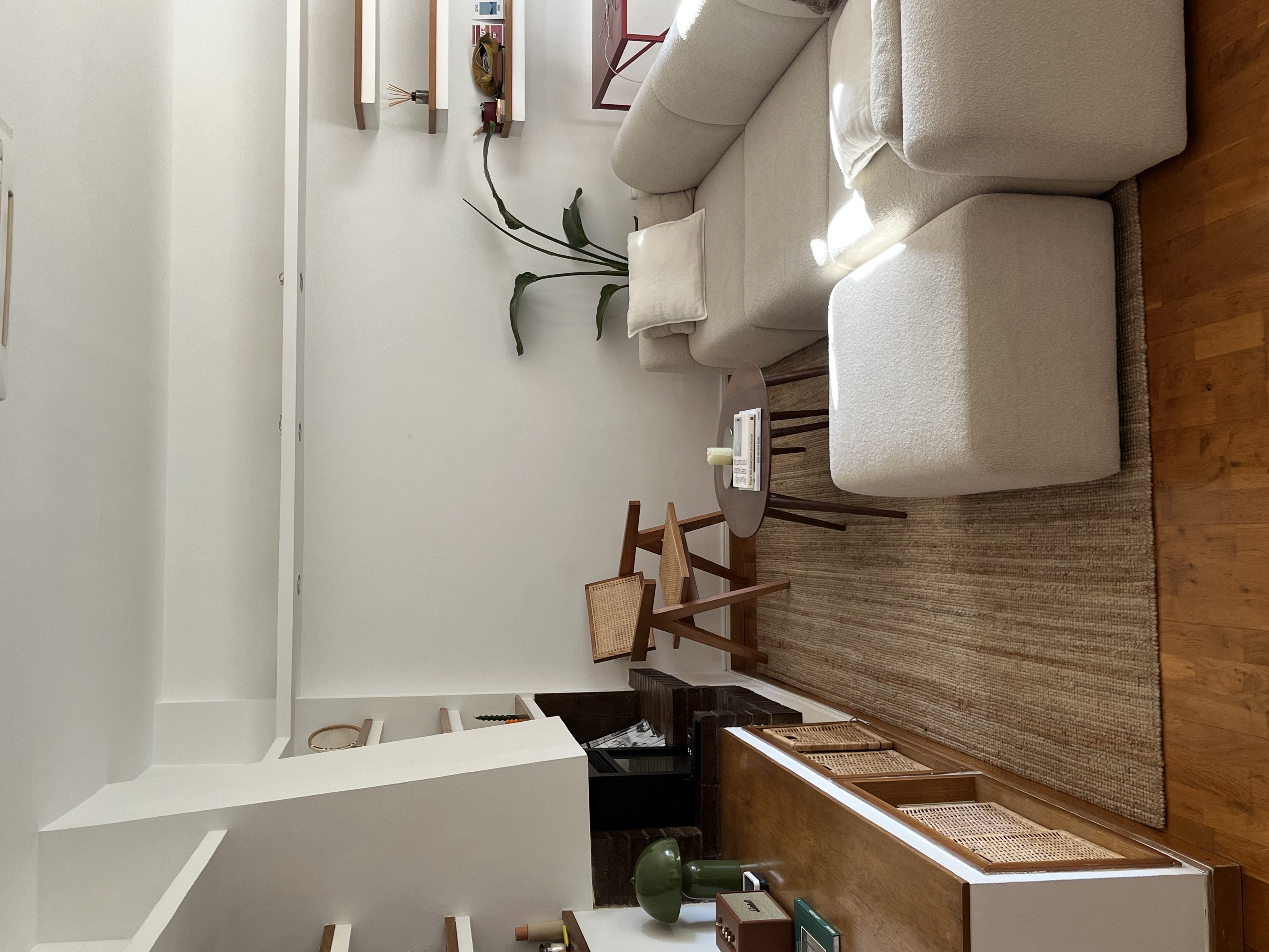 Living room wide angle with fireplace and shelving
